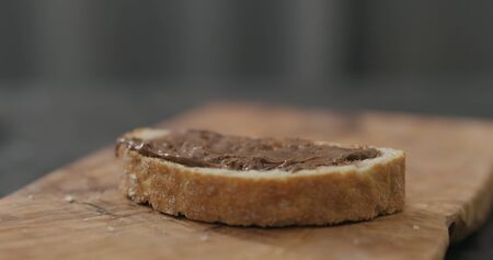 ciabatta slice with chocolate nut butter on olive board