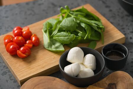 ingredients for salad, mozzarella, spinach and cherry tomatoesの写真素材