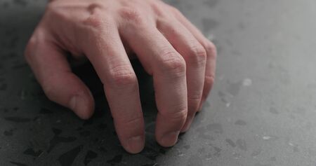 closeup man finger tapping on terrazzo countertop, wide photoの写真素材