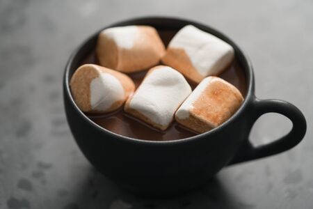 cup of hot chocolate with marshmallow on terrazzo background, shallow focusの写真素材