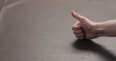 man hand checking brown leather piece closeup, wide photoの写真素材