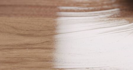 woodworker applying oil finish to black walnut board, wide photoの写真素材