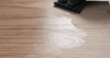woodworker applying oil finish to black walnut board, wide photoの写真素材