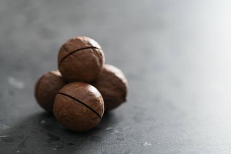 Inshell macadamia nuts on terrazzo surface with copy spaceの写真素材