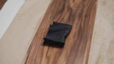 applying oil finish to black walnut board, wide photoの写真素材