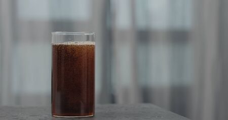 cola in glass on concrete surfaceの写真素材