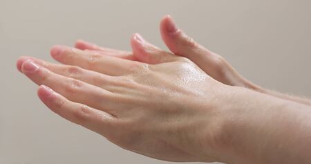 man hands apply sanitize gel on handsの写真素材