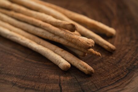 Traditional italian snack - grissini on walnut surfaceの写真素材