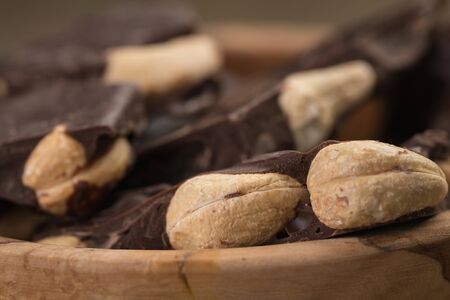 homemade dark chocolate with cashew in wood bowl