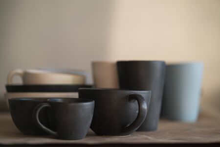 Matt ceramic handmade tableware in a workshop closeup, shallow focusの写真素材