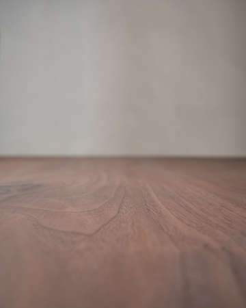 Closeup toned black walnut surface with white wall on backgroundの写真素材