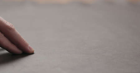 man hand checking brown leather piece closeupの写真素材