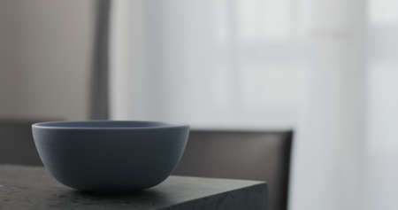Empty blue bowl on concrete countertop with copy spaceの写真素材