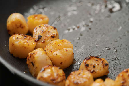 frying scallops on non stock pan closeupの写真素材