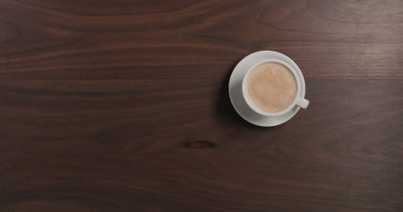 Top view hot chocolate in white cup on walnut wood tableの写真素材