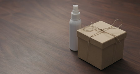 eco friendly paper gift box on walnut table with sanitizer sprayの写真素材