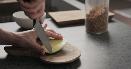 man cut green mango on olive wood boardの写真素材