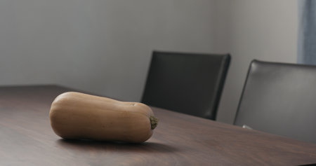 butternut pumpkin on walnut tableの写真素材