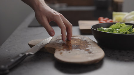 man hand touching wood board on home kitchenの写真素材