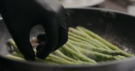 closeup of frozen asparagus put on nonstick panの写真素材