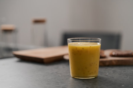 Fresh mango lulo smoothie on kitchen countertopの写真素材