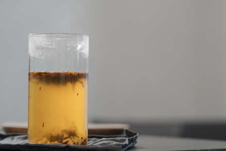 brew tea with ginger in beaker glass