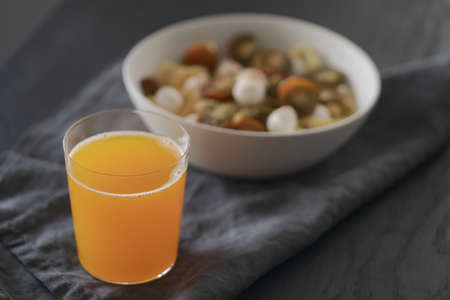 orange lemonade in glass tumbler glass on black wood tableの写真素材