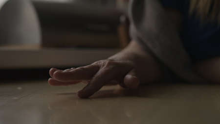 Woman sitting behind the table and finger tapping, waiting for somethingの写真素材