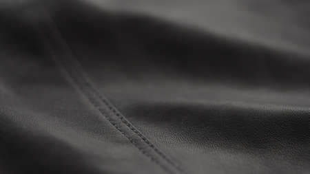 closeup of soft gray brown leather with seam