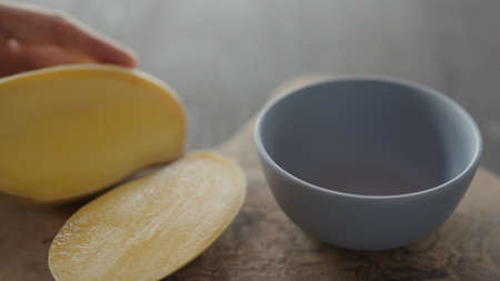 Man cut ripe thai mango on olive wood boardの写真素材