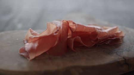 Bresaola on olive wood boardの写真素材