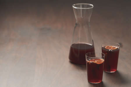 Mulled wine in tumbler glasses on walnut table with copy spaceの写真素材
