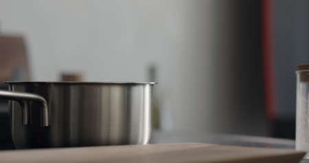 steam rising from saucepan with boiling water on stove