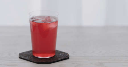 berry water over big ice rock into tumbler glassの写真素材