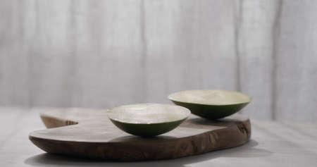 man cut green mango on olive wood board