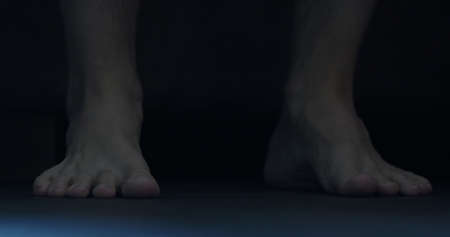 man put his feet on floor in midnightの写真素材