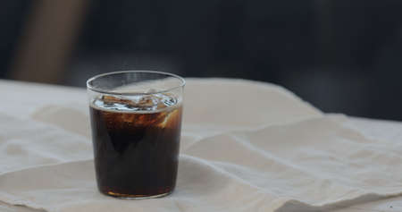 cola with ice rocks in tumbler glass