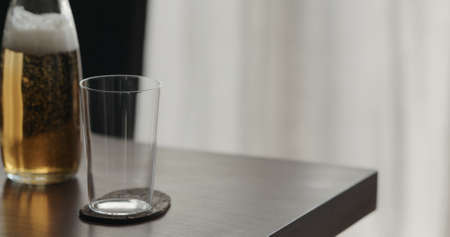 closeup mate drink in a glass bottle with tumbler glass on walnut table with copy spaceの写真素材