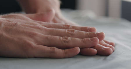 man touching cyan cotton clothes closeupの写真素材