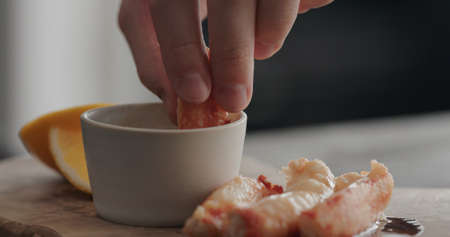 man eating crab with dip sauceの写真素材