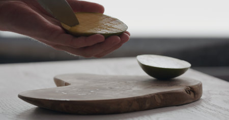 man cut ripe mango on olive wood boardの写真素材