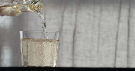 pour ginger ale in tumbler glass with copy spaceの写真素材