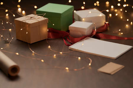 White paper notepad with pencil on wood table with christmas decorationsの写真素材