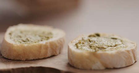 pesto on fresh baguette slice to make sandwich closeupの写真素材