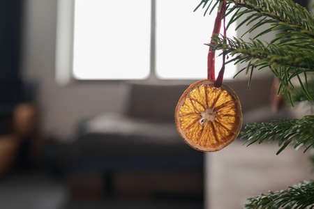 Closeup small christmas tree with natural decorations indoorの写真素材