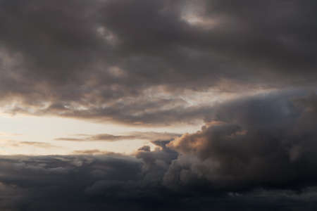 Dramatic storm clouds with sunset lightの写真素材