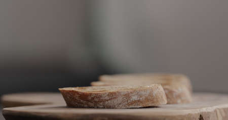 dark ciabatta bread slice on olive boardの写真素材