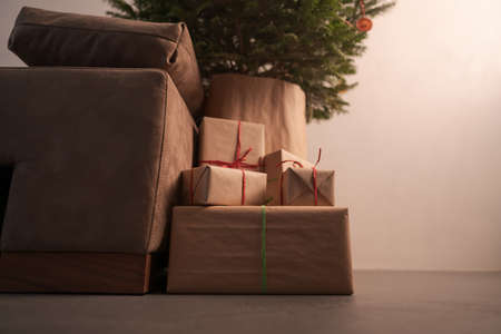 gift boxes under christmas tree with warm lightの写真素材