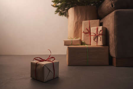 gift boxes under christmas tree with warm light