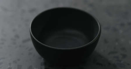 Empty ceramic bowl on concrete countertopの写真素材
